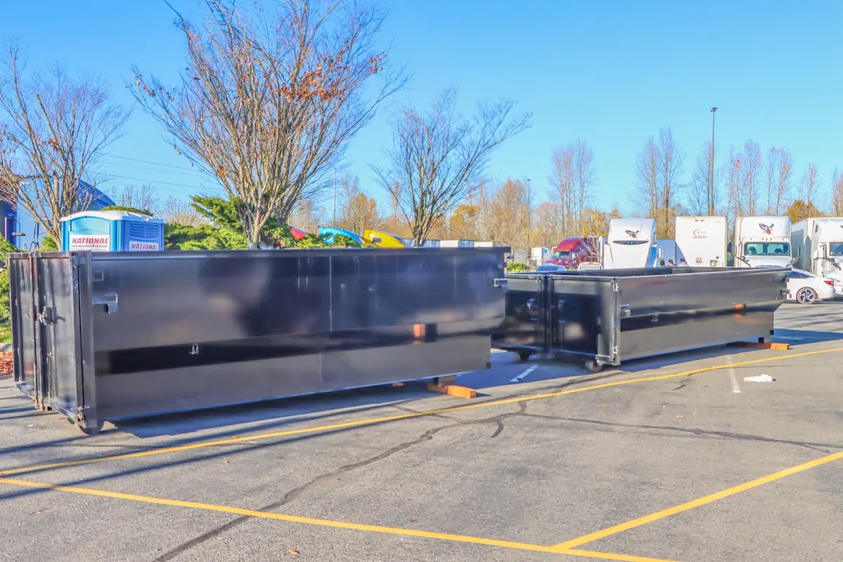 Professional dumpster rental service with roll-off container on residential driveway in Arlington